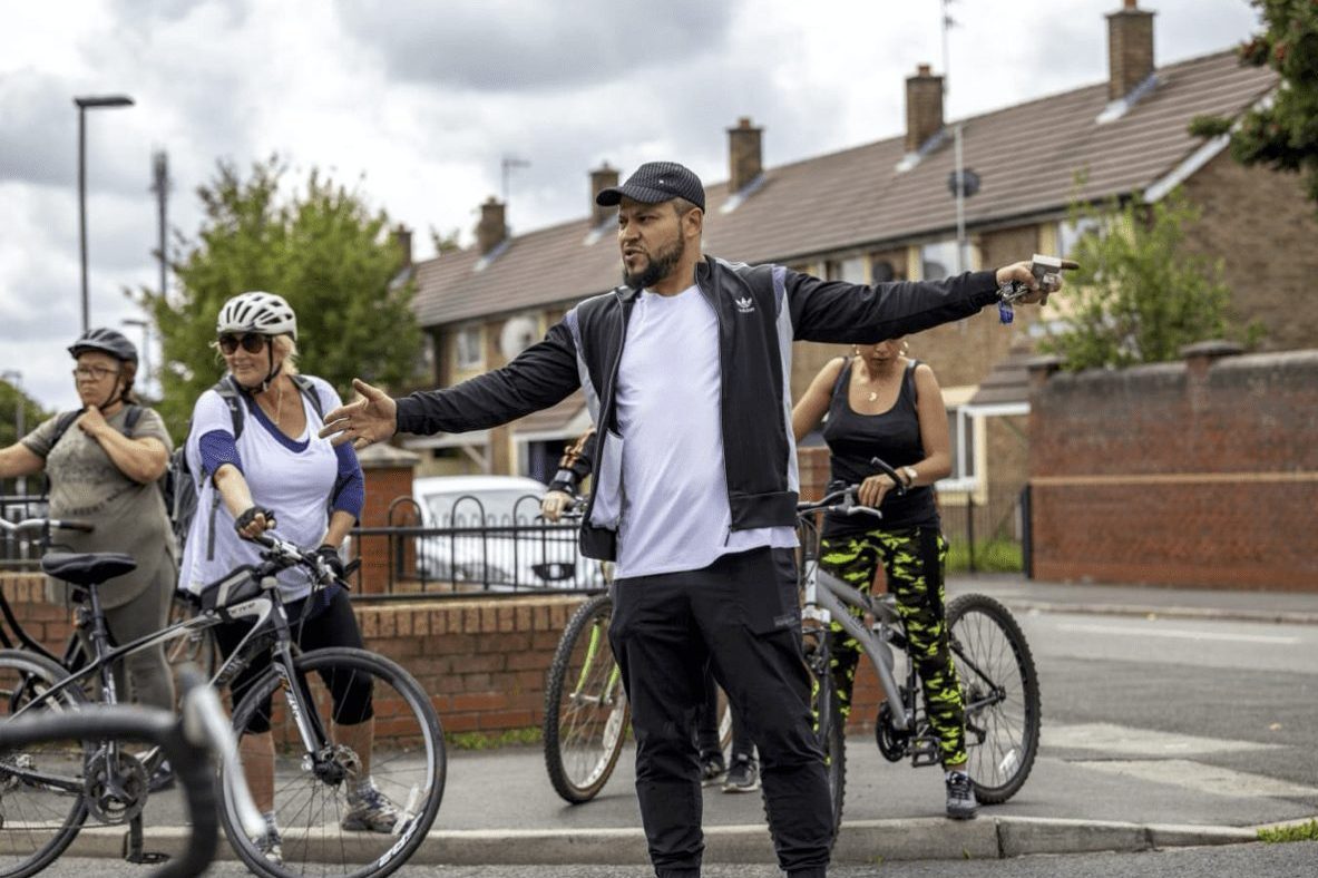 A group of people learn to cycle with Cycle for Life.